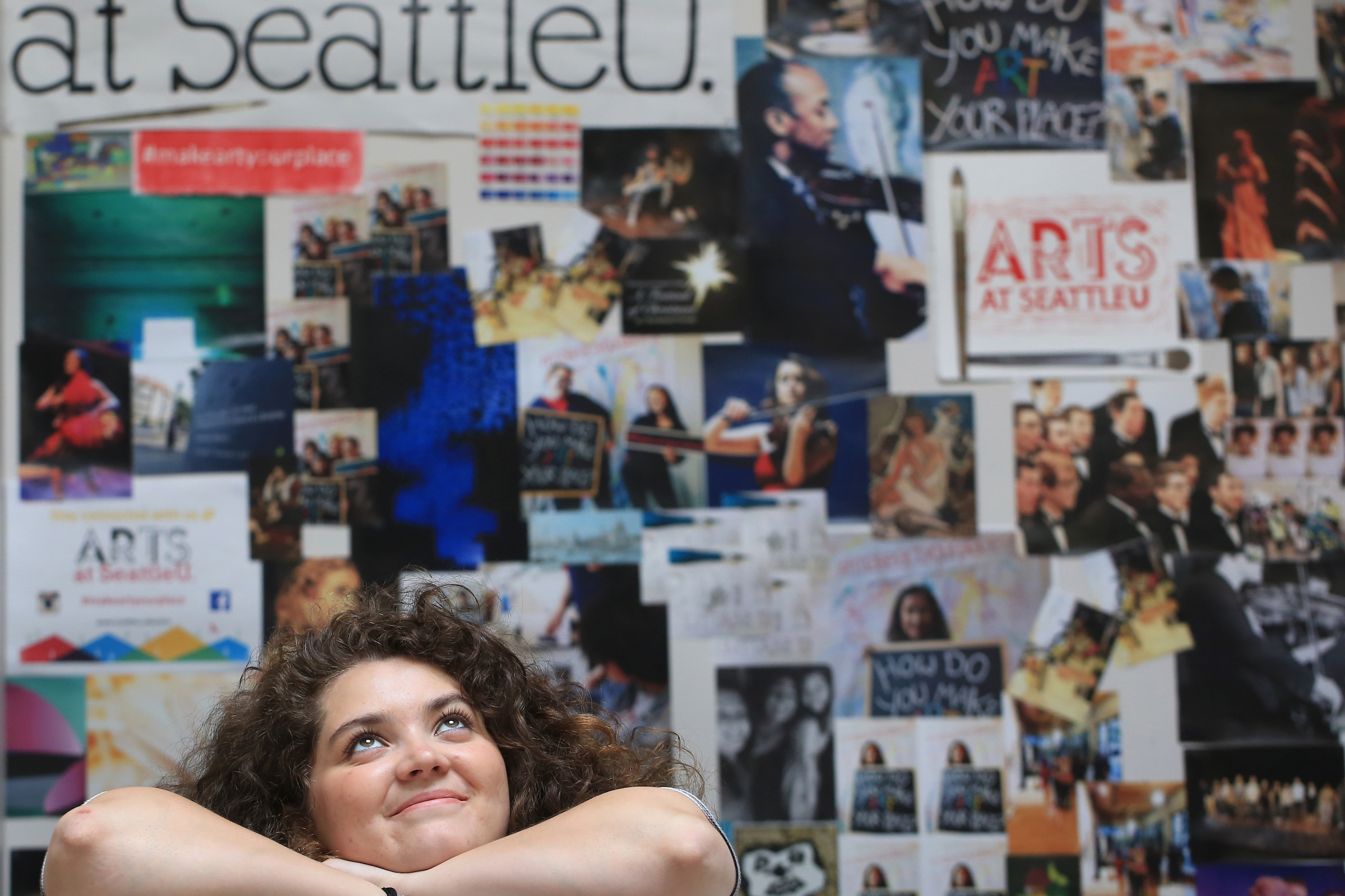 Meme Garcia, '15, Fulbright scholar, and double major in theatre and women & gender studies, posed in front of an Arts at Seattle U collage.